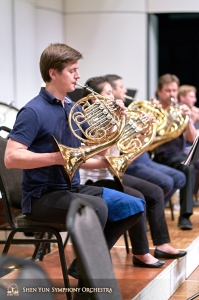 Andrei Bekhterev and the French horn section cool down after rehearsal.